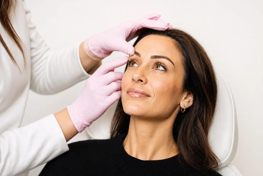 A clinician assessing a client’s skin at neoSKiN