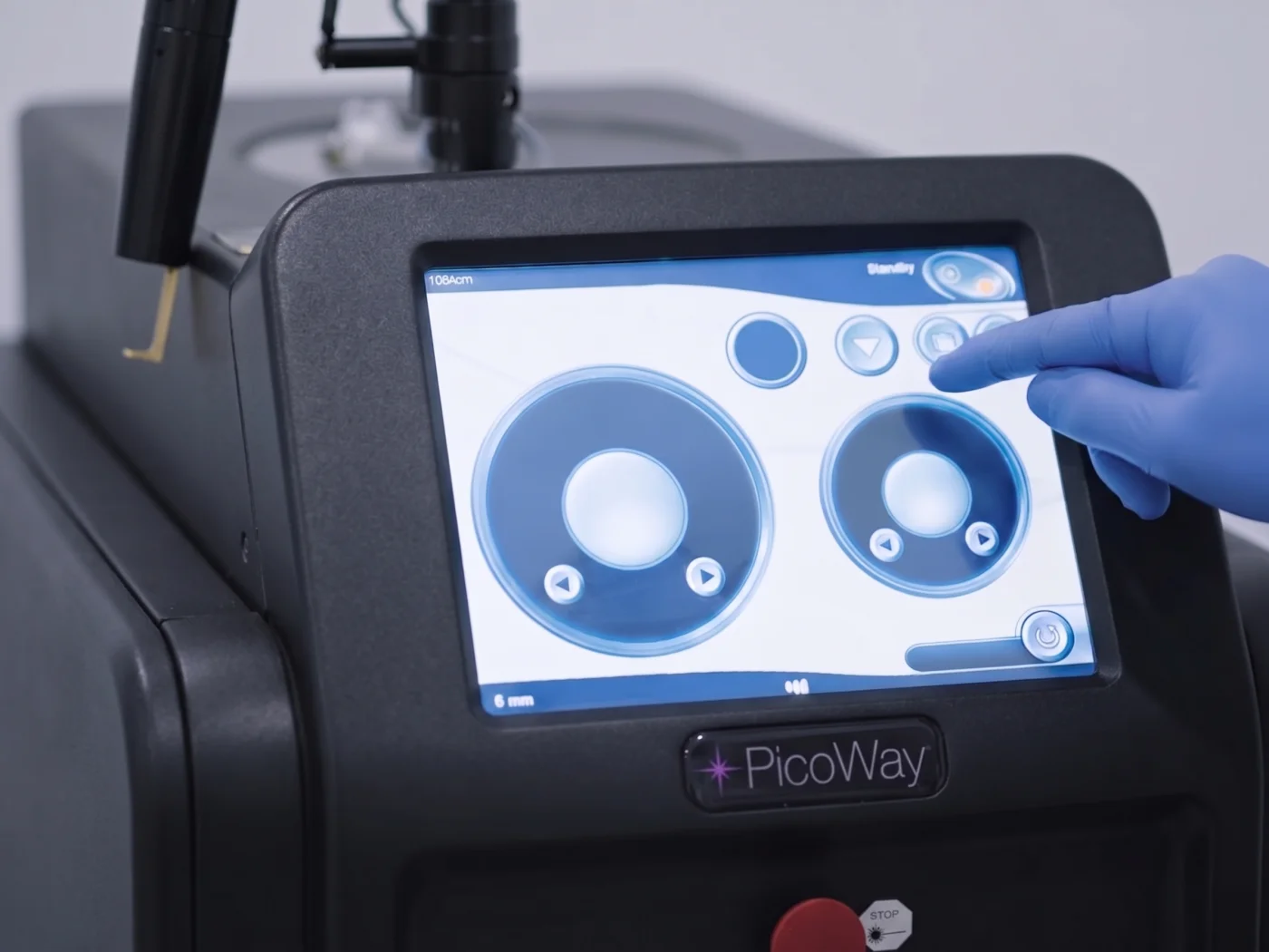 Gloved clinician adjusting the PicoWay laser console